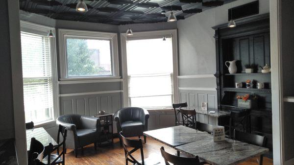 This is another seating area with tables and those leather chairs by the bay window.