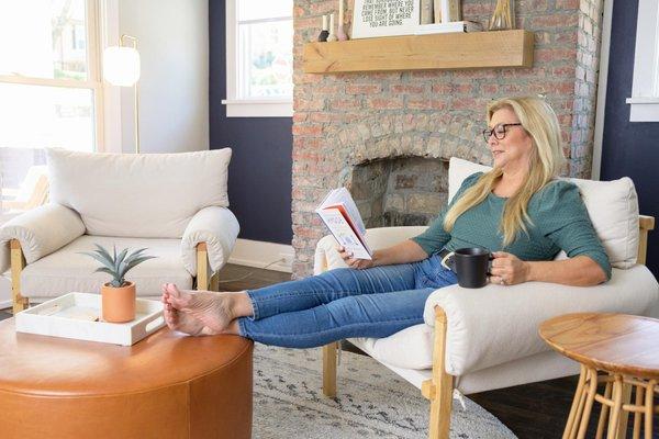 woman sitting on a chair reading