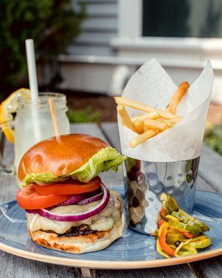 Our Hastings Burger with Aged Cheddar, Lettuce, Tomato, Onion, and House-made Pickles.