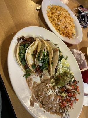 Carne asada tacos with one chorizo taco side of rice with queso