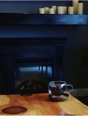 Enjoying a cup of tea near our fireplace!