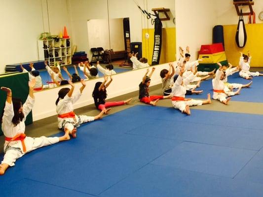 Girls karate, stretching.