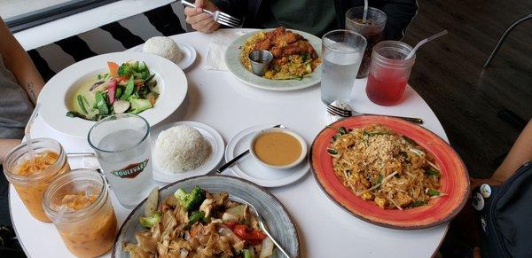 Drunken noodles with chicken, green curry, mango fried rice with chicken and orange sauce, spicy basil pad thai with tofu.