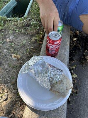 A burrito with barbacoa and drinks