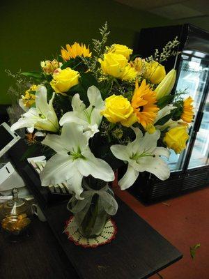 Lilies and yellow flowers.  Its a large arrangement for that special someone. Show them how much you care.