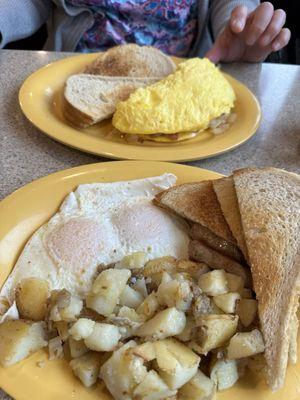 Very fluffy ham and cheese omelette with sourdough bread. Two eggs over easy with home fries and sourdough bread.