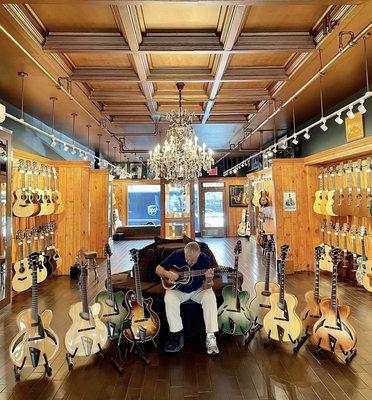 Rudy surrounded by amazing archtops in our acoustic room