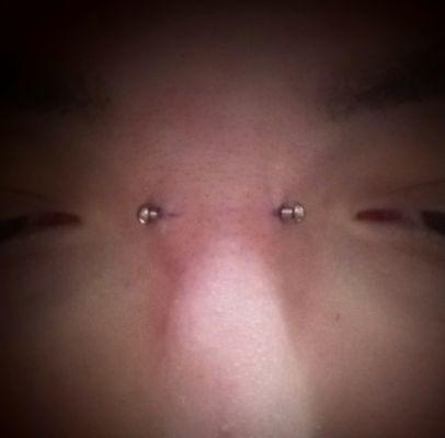 Titanium Threadless barbell for this bridge piercing.