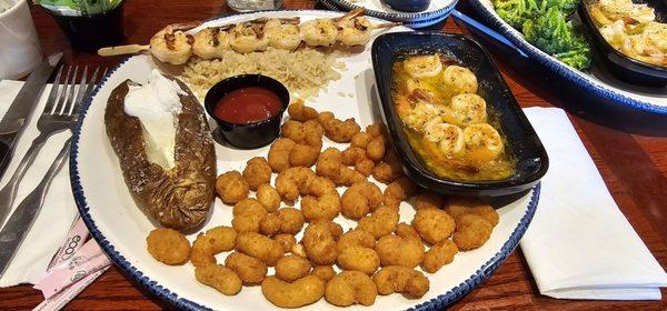 Shrimp Your Way I ordered the 3: popcorn shrimp, scampi and grilled shrimp on a bed of rice and a baked potato and a water with extra lemon