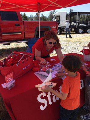 Katie helping a child at The Touch-A-Truck fundraiser in Scotts Valley