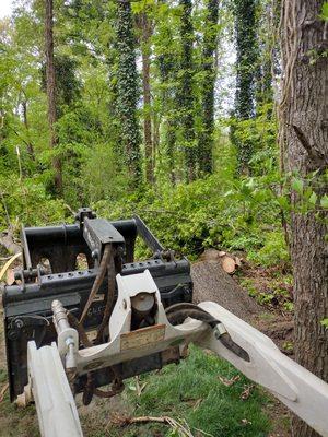 The bobcat moved the wood easy.