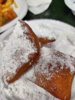 French Beignet with powder sugar all over.