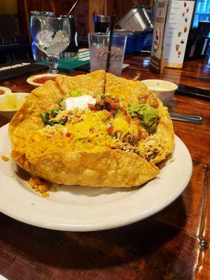 Chicken taco salad with refried beans and rice.