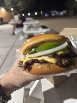 double PH burger with onions and jalapeños