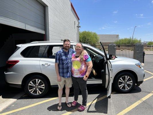 Happy customers with their new car