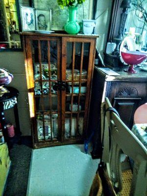 A small shelf with doors that are wood not best condition but I have to or someone needs to give TLC or use drawers for another piece,!