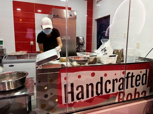 Employee handcrafting boba.