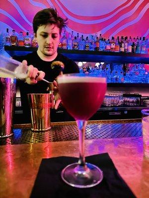 Cam, our bartender, mixing cocktails