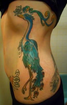 Peacock tattoo on my left side, restored and colored by Toby