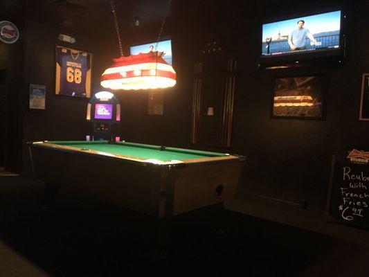 Pool table with big screens.