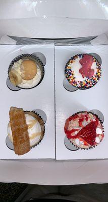 Top left: banana pudding cupcake Bottom left: churro cupcake Top right: animal cookie cupcake Bottom right: strawberry cupcake