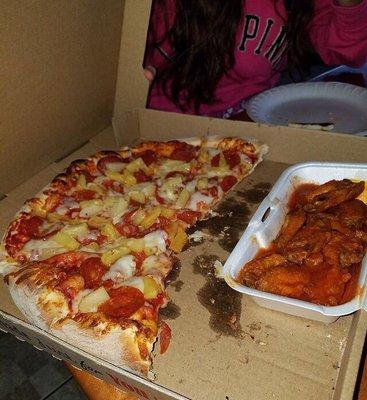 Pepperoni and pineapple pizza. With hot wings