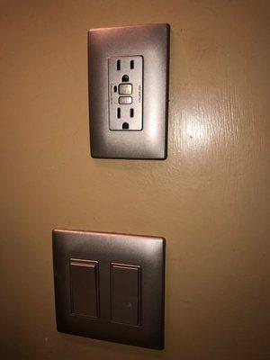 Grey power outlet and paddle switches. Notice there are no visible screws!