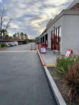 Outside: tire pressure check & fill line runs along the side of the shop along with the customer check in entrance