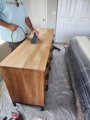 Refinishing a dresser.