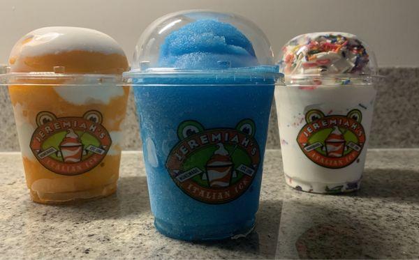 Orange gelati, blue raspberry slushy and vanilla soft serve with rainbow sprinkles