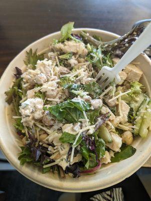 Salad with cucumber, broccoli, chick peas, Parmesan, chicken, sesame seeds and their amazing ranch dressing.