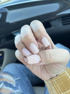 Two bleeding cuticles, sanded over by a "nail tech". Whichever school gave this lady a license should be shut down.