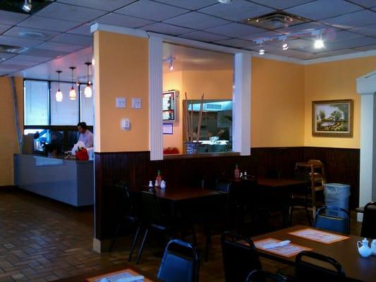 The larger dining area is partially separated from the entrance and counter