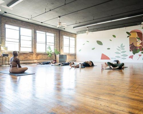 Students take a yoga class in the studio.