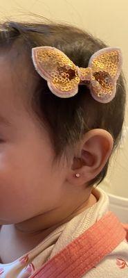 Baby ear piercing.