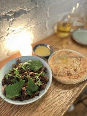 Lamb with pita and green harissa