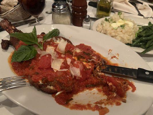 Veal Parmigiana on the bone with side of mashed potatoes and string beans