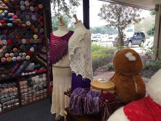 Many shawl examples scattered around the shop.