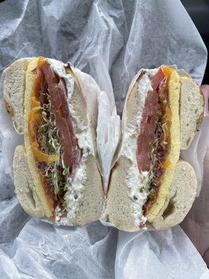 Breakfast sandwich- Asiago bagel, jalapeño cream cheese, egg, cheddar, bacon, tomato, and sprouts