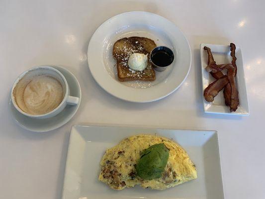 Cappuccino  Omelet (build your own w/ bacon, Gouda, avocado) Came with side (I chose French toast) Additional Side - bacon