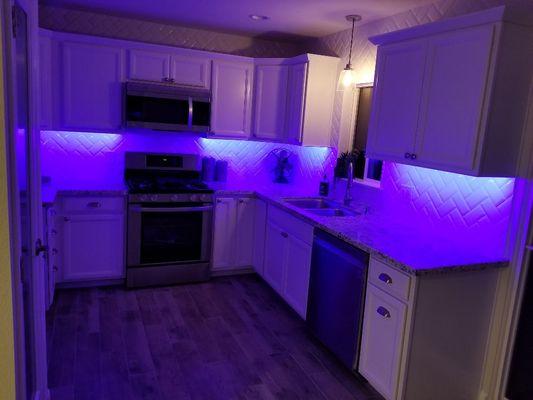 Full kitchen renovation with ceiling height backsplash and cool lighting...