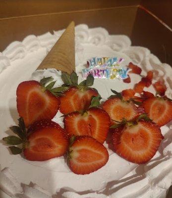 My daughter's cake with fresh strawberries she cut right before we took the cake home.