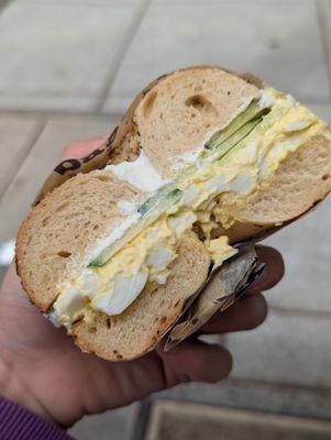 Egg salad and cucumber on everything bagel