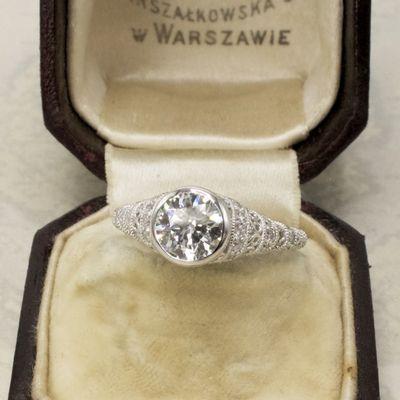 A 1.01 carat diamond is bezel set in this Art Deco style solitaire.