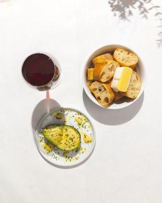 Avocado, bread and butter, a glass of red wine-- LA's finest lunch indulgence.