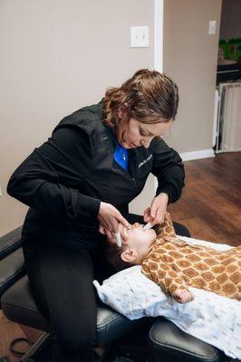 Dr. Ruddle adjusting pediatric patient. Cranial adjustments sometimes require treatment from inside the mouth.