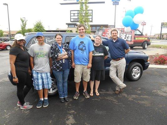 Easy Auto car giveaway winners with store manager Rick!