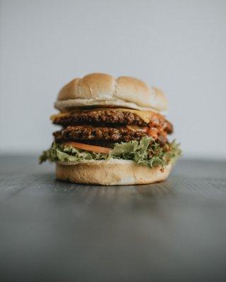 Indigō Burger made with double Impossible™ patty. 100% Plant-based.