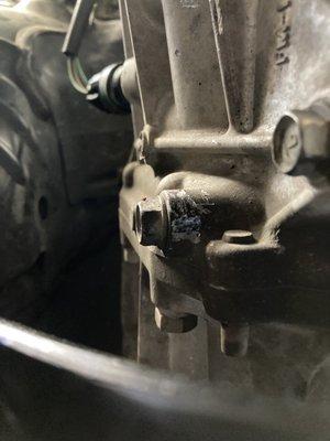 Damage to the transmission case caused by Acur-It Auto