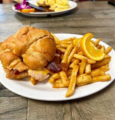 TBA, Turkey, bacon, Avocado, cheese and lettuce on a croissant, it was good.  The fries were crispy and also good.